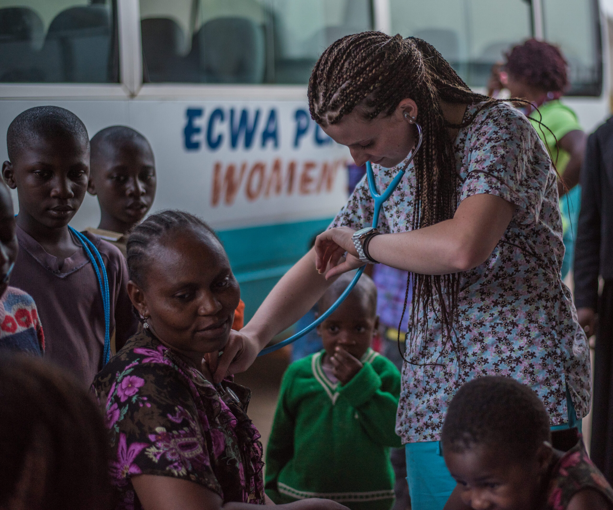Medical volunteer examining a child during an IMO outreach clinic